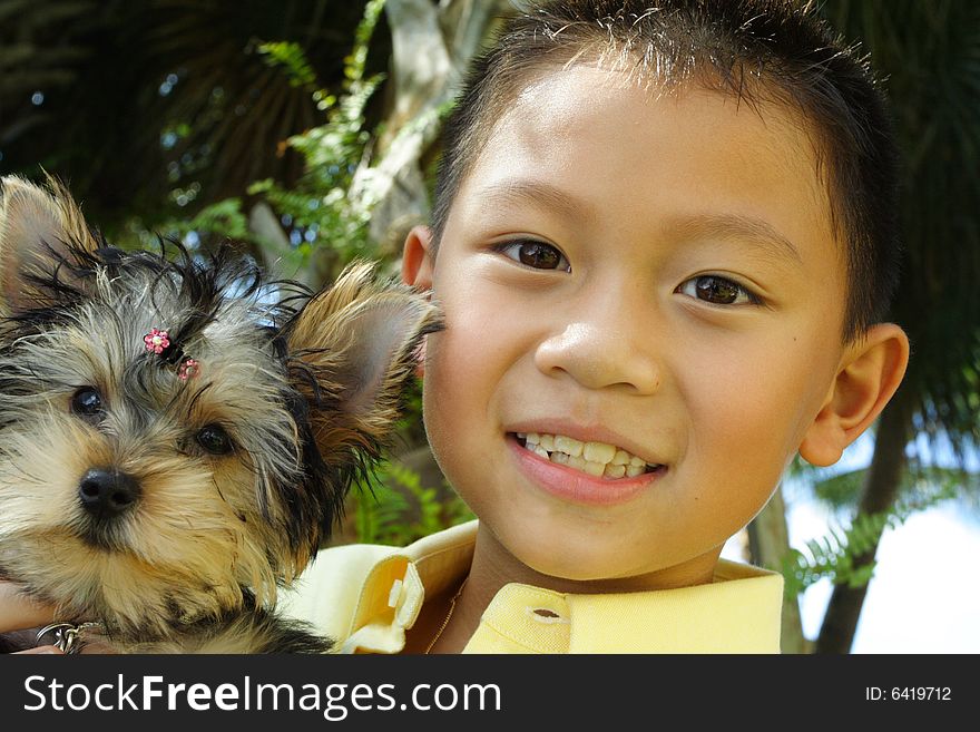 Boy holding his puppy