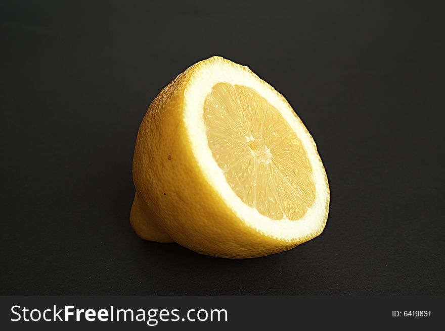 Half of a lemon black background. Half of a lemon black background