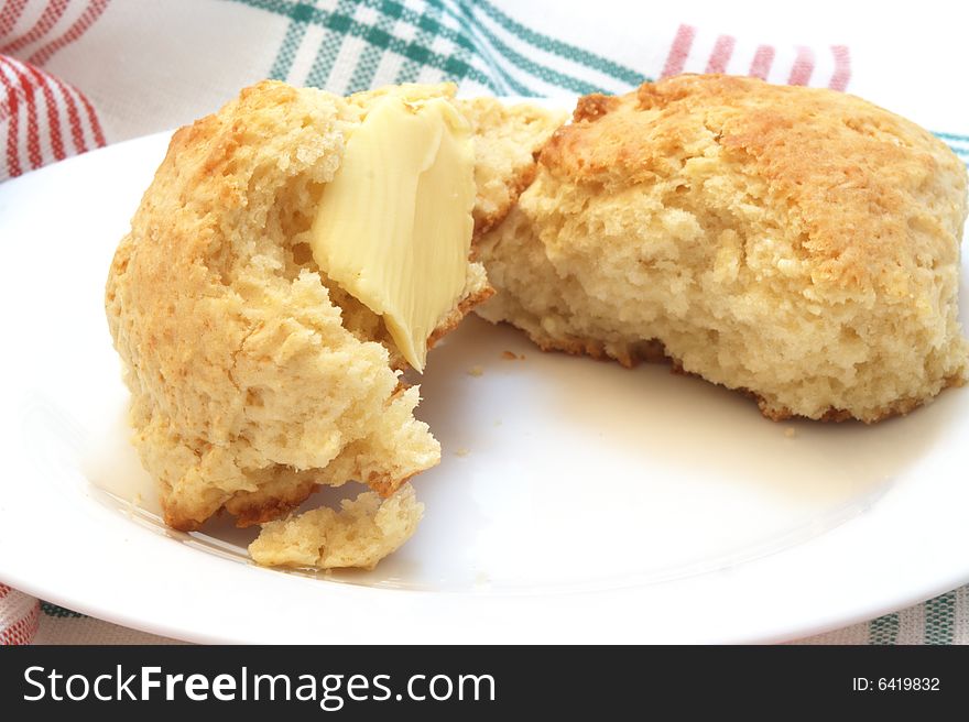 Home made buttery scones on white plate. Home made buttery scones on white plate