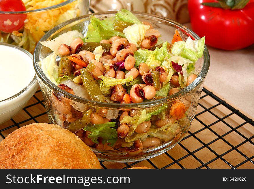 Glass bowl of black eye pea salad in kitchen or restaurant. Glass bowl of black eye pea salad in kitchen or restaurant.