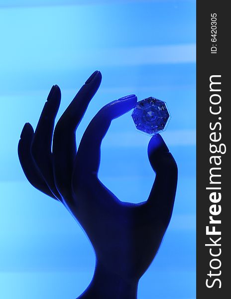 Blue gem in the hand. Blue gem in the hand