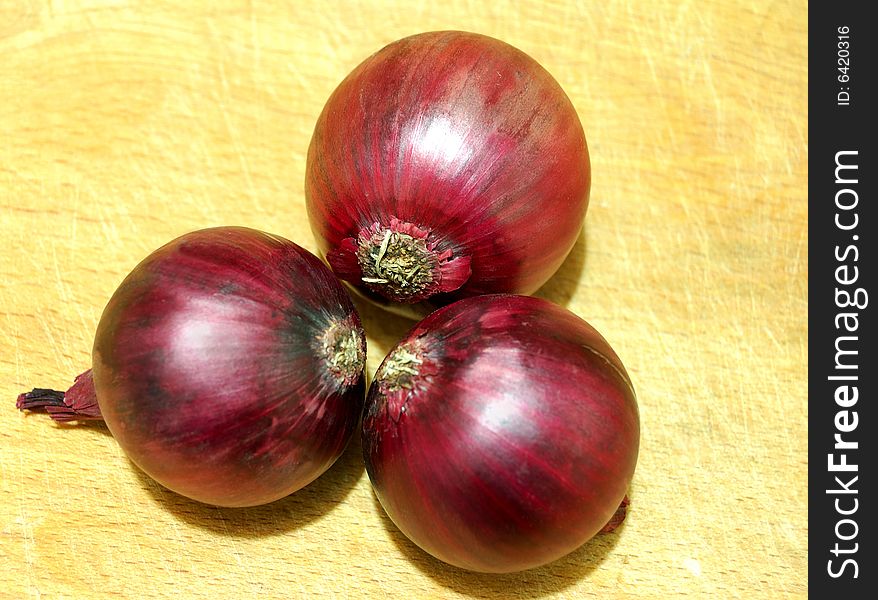 Red onion on wood board. Red onion on wood board