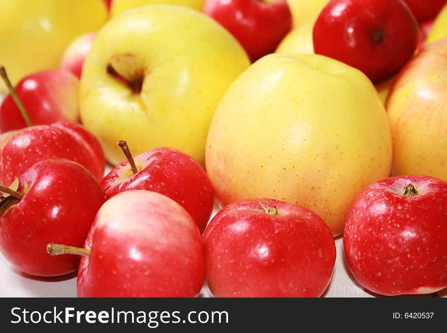 Yellow and red apples against the white background