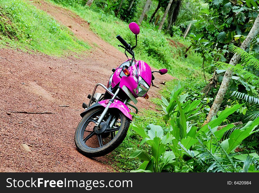 A pink Hero Honda Splendor motor bike. A pink Hero Honda Splendor motor bike.