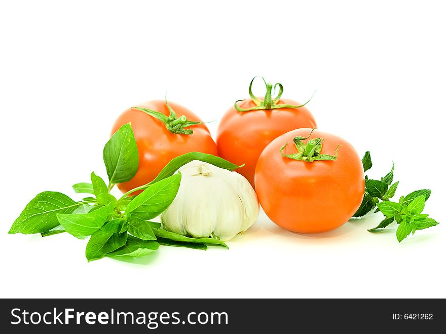 Ripe fresh vegetables with two kinds of basilico over white