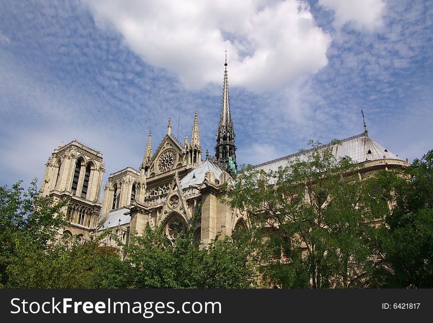 Notre Dam cathedral of Paris, horizontal, blue sky and trees