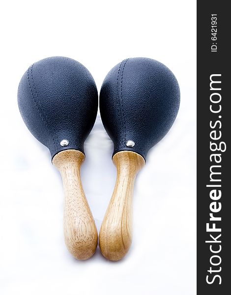 Pair of black plastic maracas isolated on white with wooden handle