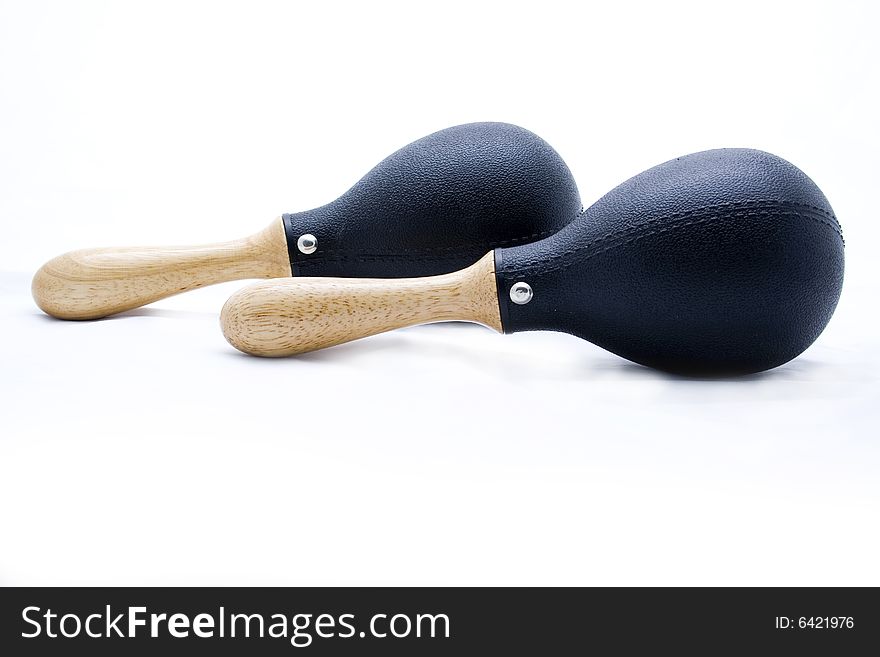 Pair of black plastic maracas isolated on white with wooden handle