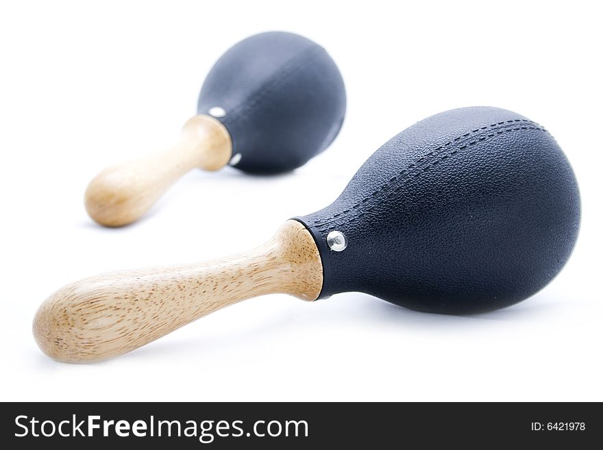 Pair of black plastic maracas isolated on white with wooden handle