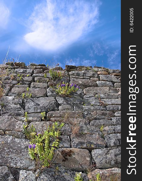 An irish old irish wall in Kerry on the west coast of Ireland with a sky background. An irish old irish wall in Kerry on the west coast of Ireland with a sky background