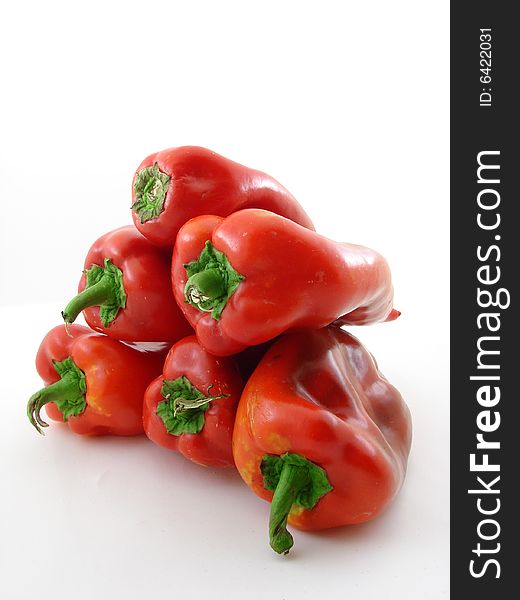 Fresh picked red peppers isolated over white background.