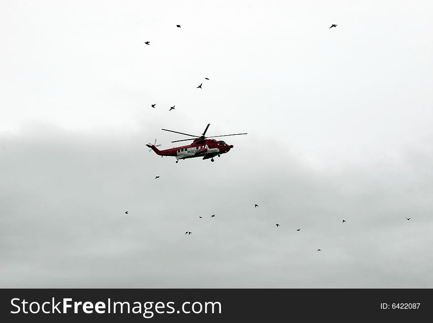 A helicopter on a life air sea rescue mission. A helicopter on a life air sea rescue mission