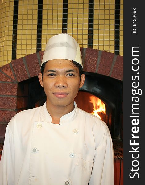 Chef standing at front of pizza oven. Chef standing at front of pizza oven