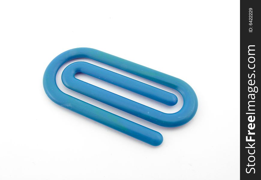 Blue plastic paper clip isolated over white background.