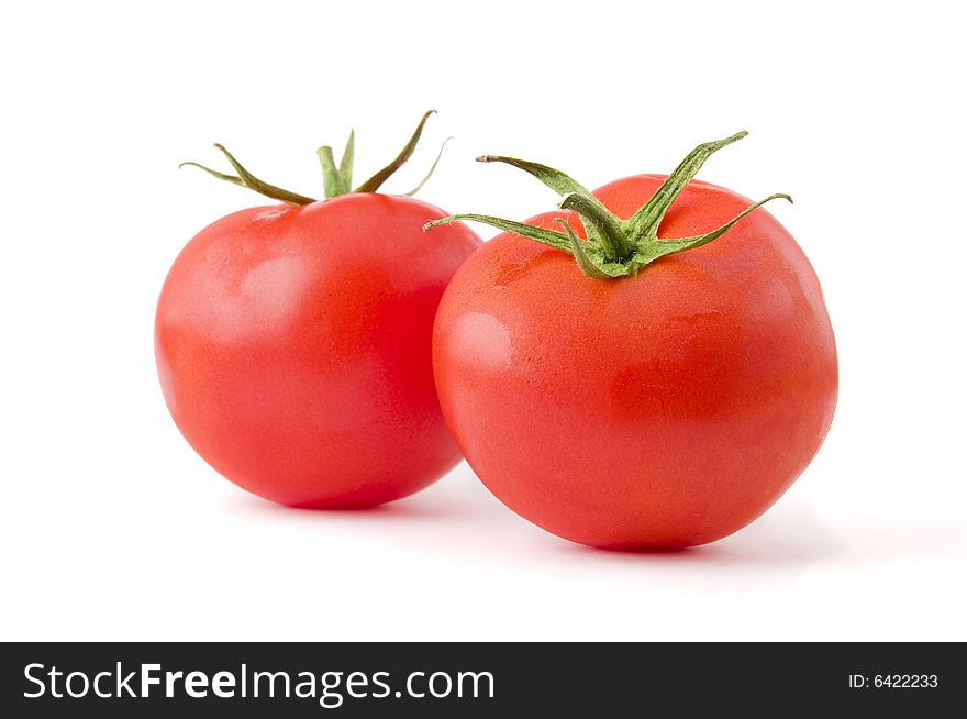 Two fresh and ripe tomatoes isolated on white background. Professional studio image. Two fresh and ripe tomatoes isolated on white background. Professional studio image
