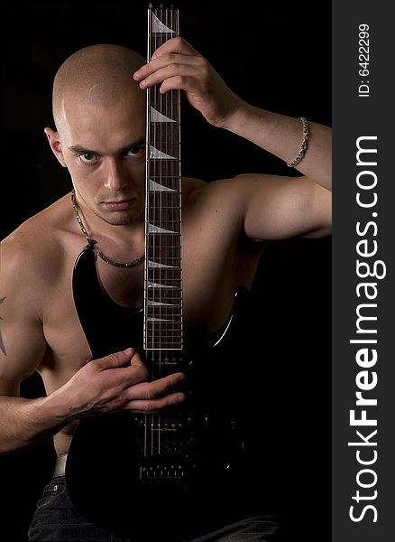 Portrait of the guitarist on a black background