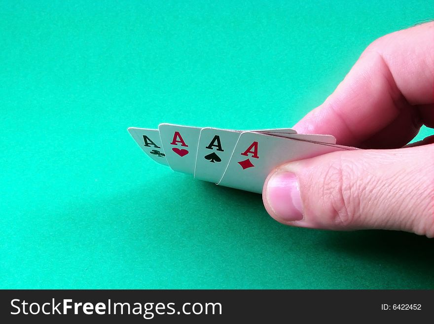 Poker ace in hand and green desk