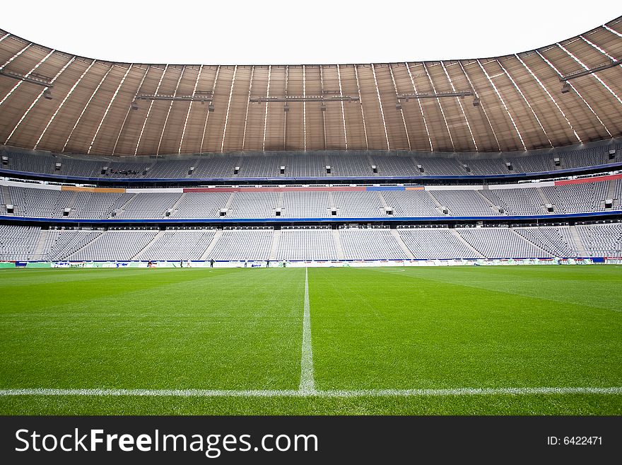 The halfway line on a football pitch in a stadium setting. The halfway line on a football pitch in a stadium setting.