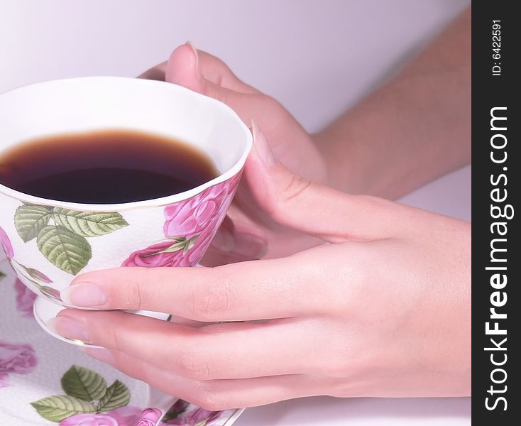 Female hands hold a coffee cup or tea