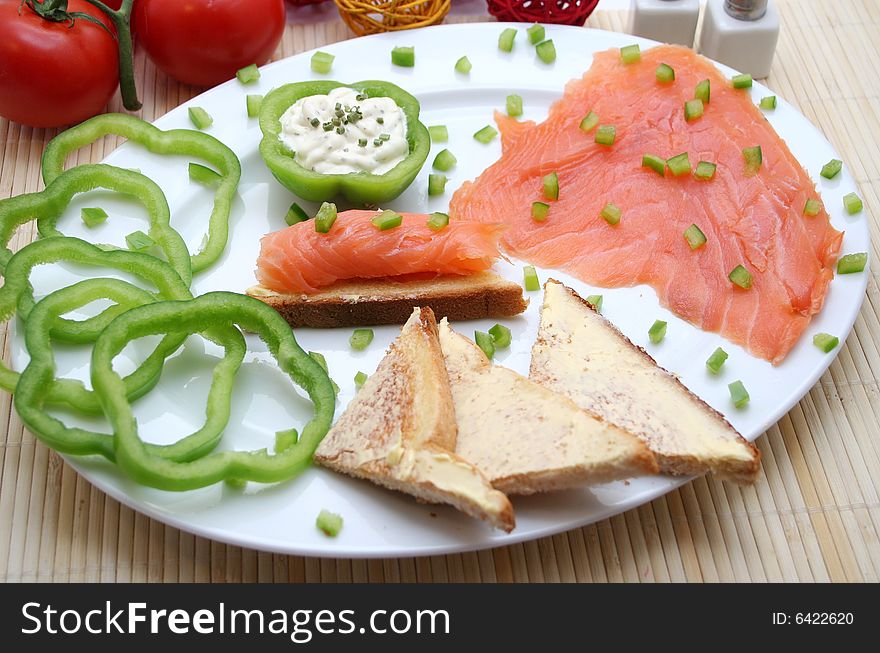 A breakfast of fresh salmon and some bread. A breakfast of fresh salmon and some bread