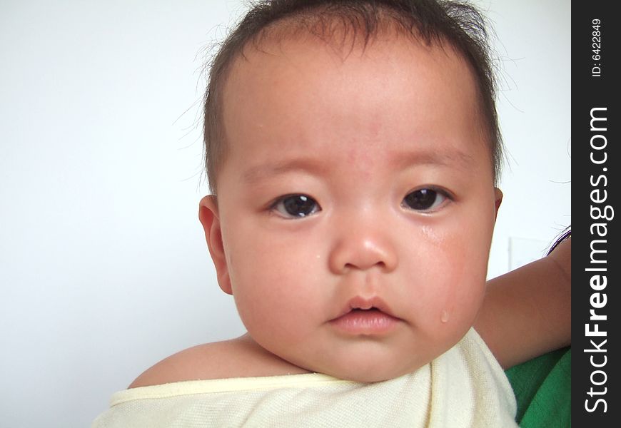 Infant with tears in her mother's arm. Infant with tears in her mother's arm