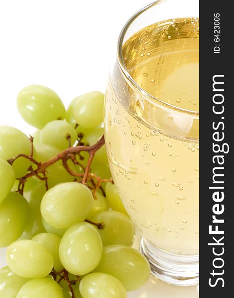 Spritzer in a glass with grapes on white background
