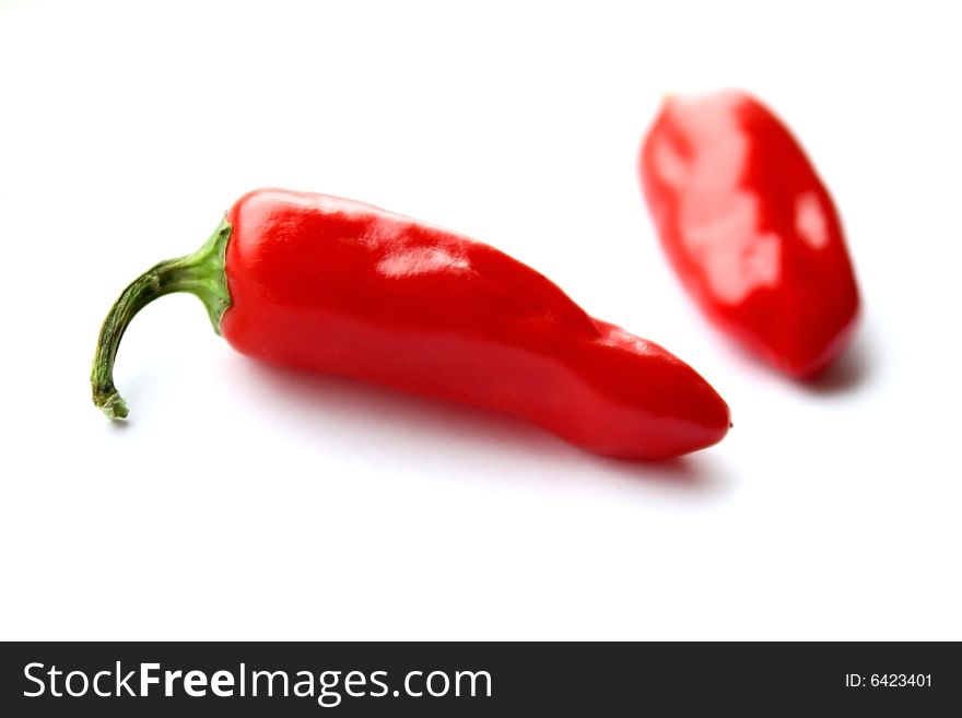 Two red chilis isolated on a white background