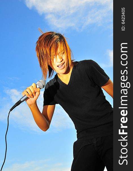 Picture of a young generation rock star with a microphone. Suitable for musical related contexts. Picture of a young generation rock star with a microphone. Suitable for musical related contexts.