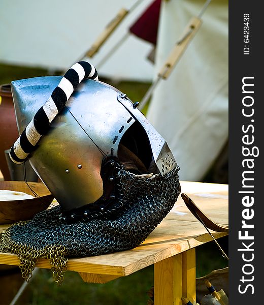 Helmet of the knight on the wooden table. Helmet of the knight on the wooden table