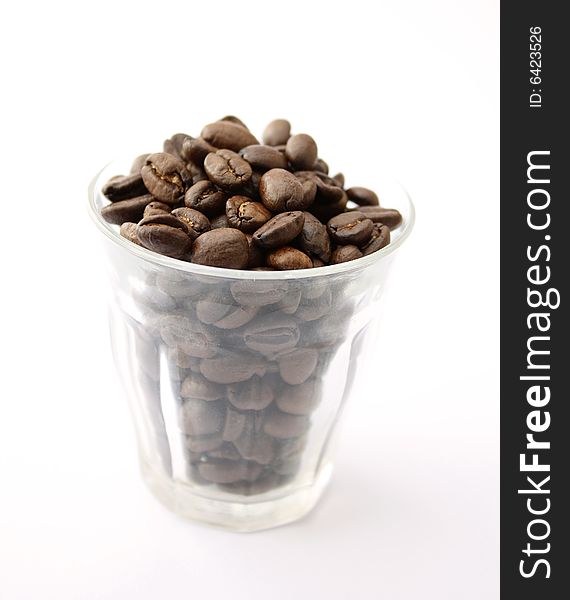 An espresso cup full of coffee beans
