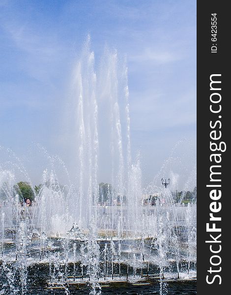 Beautiful fountain in park in summer shiny day