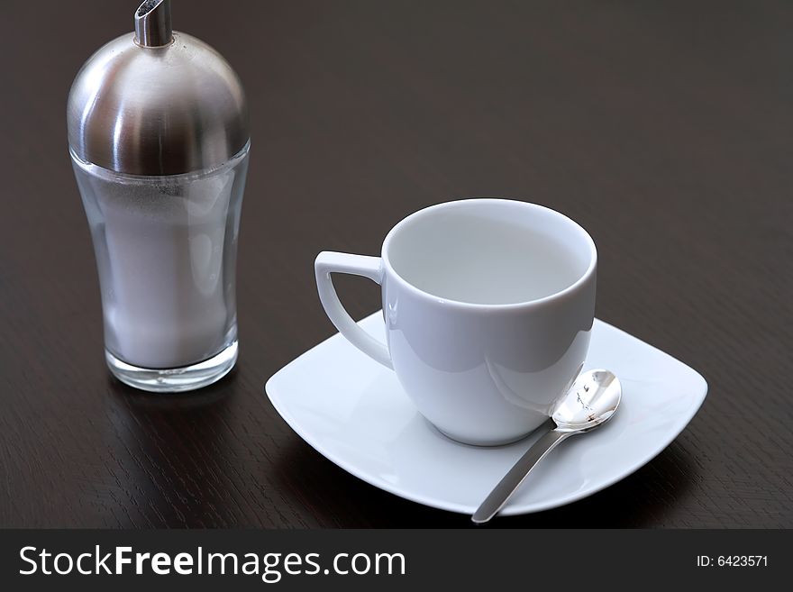 Capucchino cup on a brown table