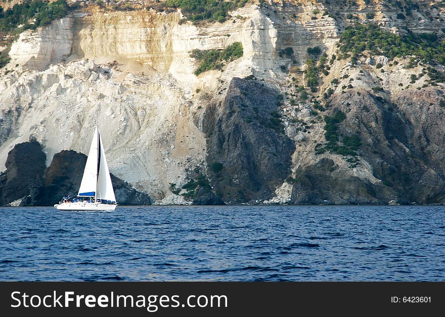 Small yacht on mountain background