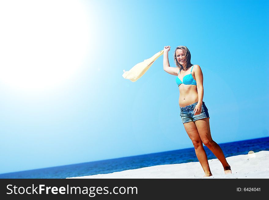 Young attractive woman enjoying summertime on the beach. Young attractive woman enjoying summertime on the beach