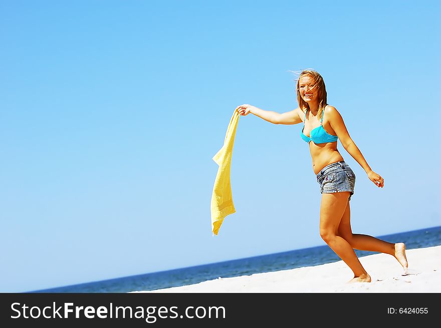 Young attractive woman enjoying summertime on the beach. Young attractive woman enjoying summertime on the beach