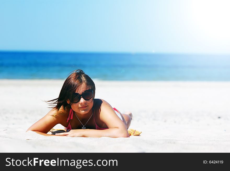 Beautiful woman relaxing on the beach. Beautiful woman relaxing on the beach
