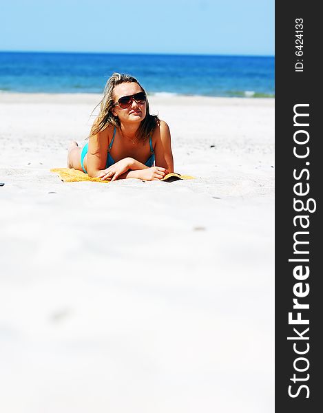 Young attractive woman enjoying summertime on the beach. Young attractive woman enjoying summertime on the beach