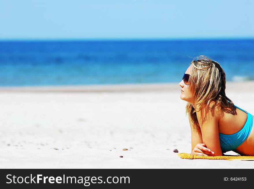 Beautiful woman relaxing on the beach. Lots of useful copyspace. Beautiful woman relaxing on the beach. Lots of useful copyspace