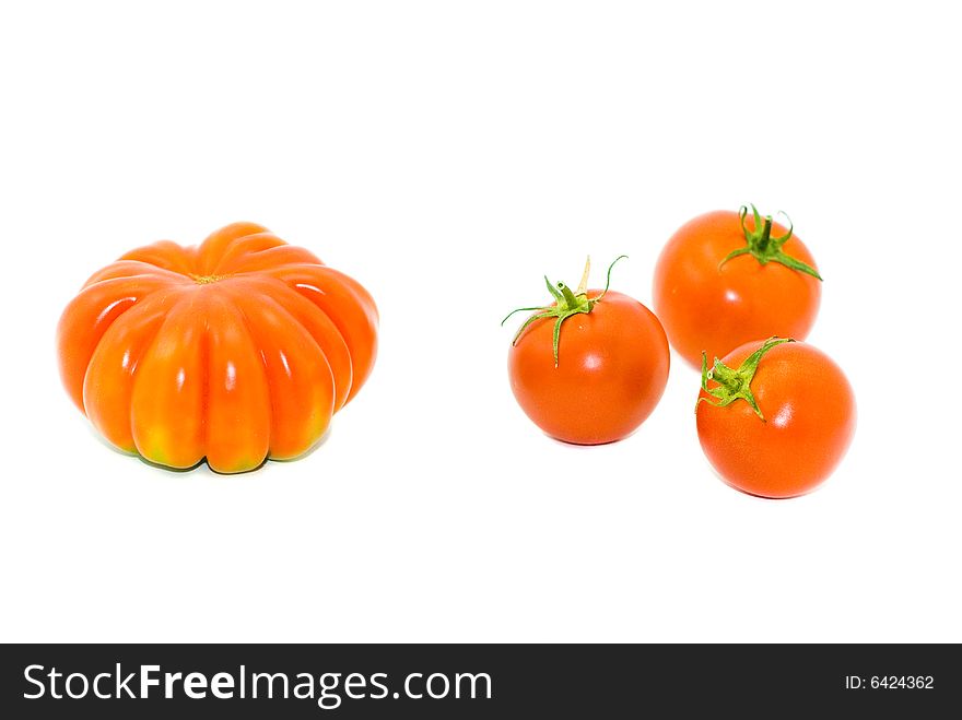 Round small and big red tomatoes on a white background. Round small and big red tomatoes on a white background