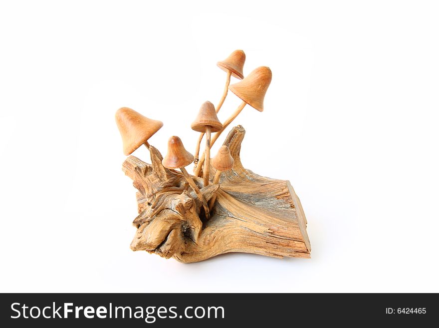 Wooden mushrooms at white background