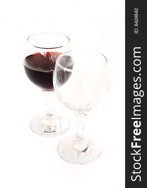 Glass with red wine at white