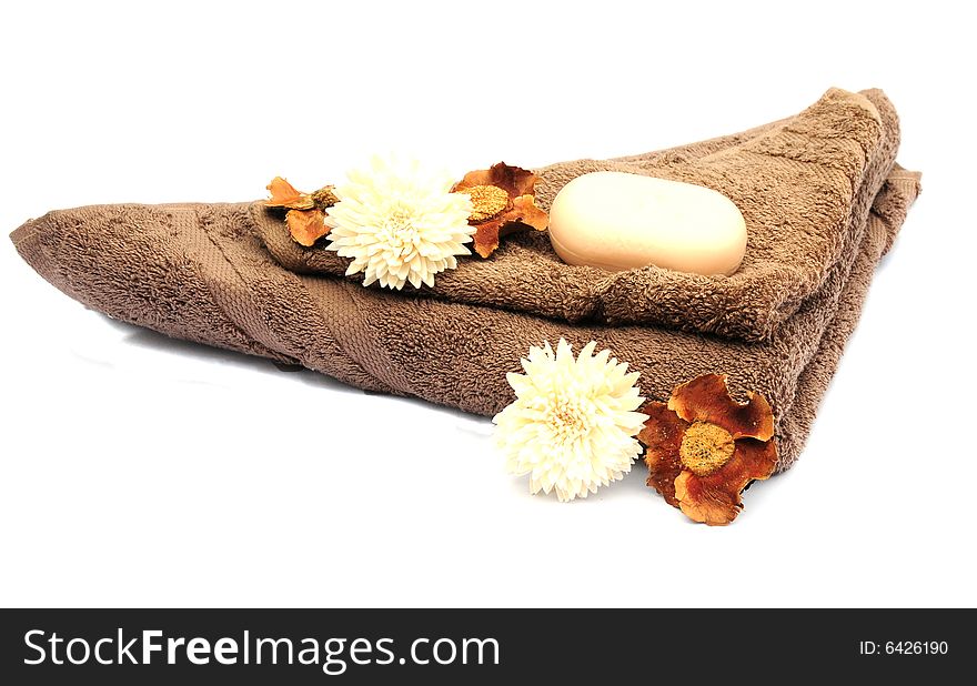 Shot of three different coloured towels and flowers