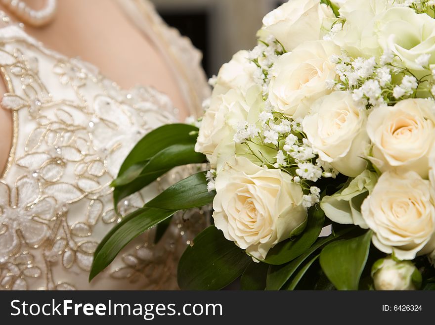 Details of the bride's dress and bouquet of flowers. Details of the bride's dress and bouquet of flowers