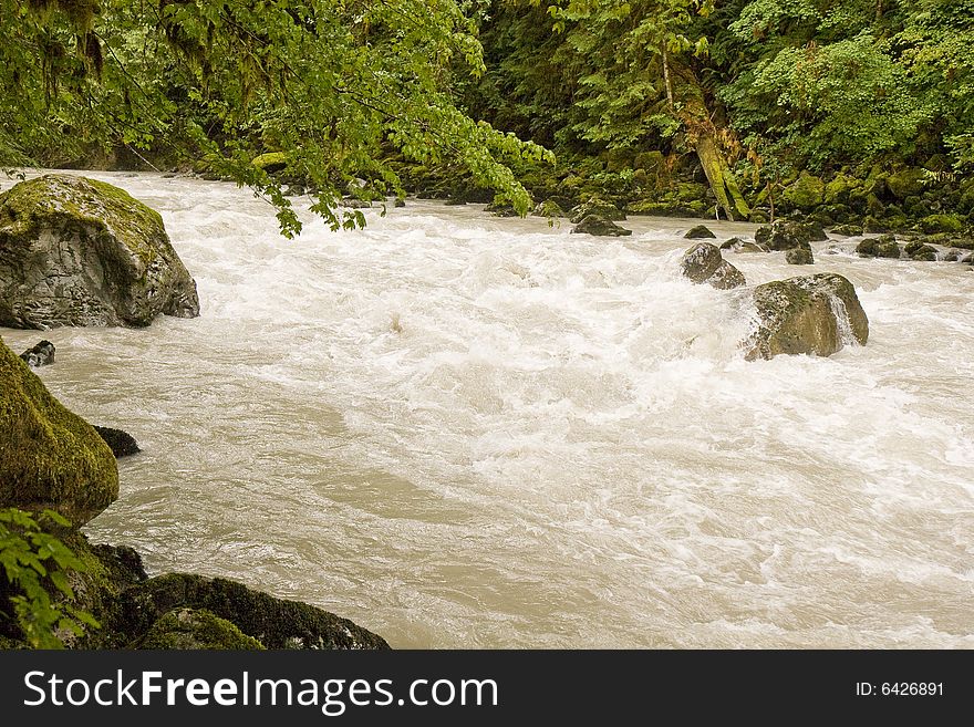 A mountain stream rushing through the rocks. A mountain stream rushing through the rocks