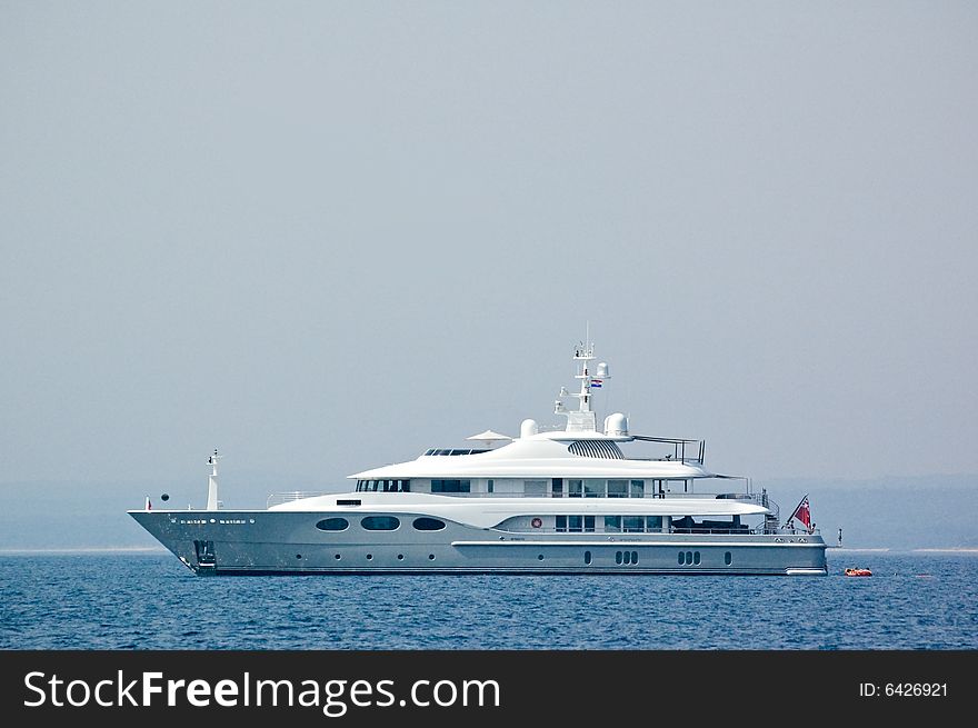 View on a majestic yacht ploughs water of the Mediterranean sea. View on a majestic yacht ploughs water of the Mediterranean sea