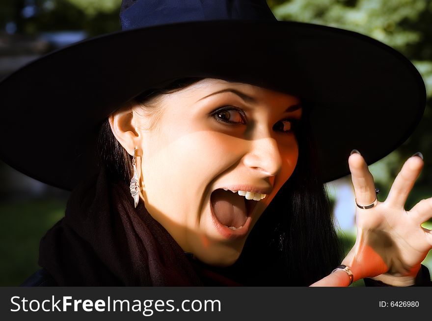 Screaming witch in black hat. Screaming witch in black hat