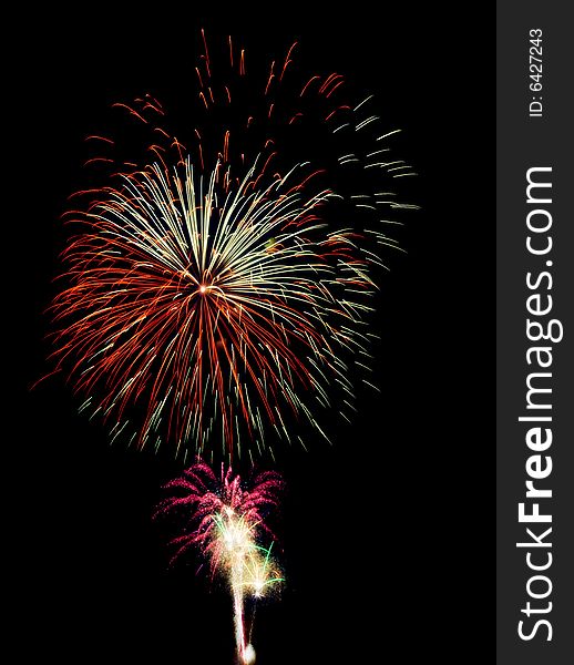 Fireworks composition photographed with long exposure, isolated on black.
