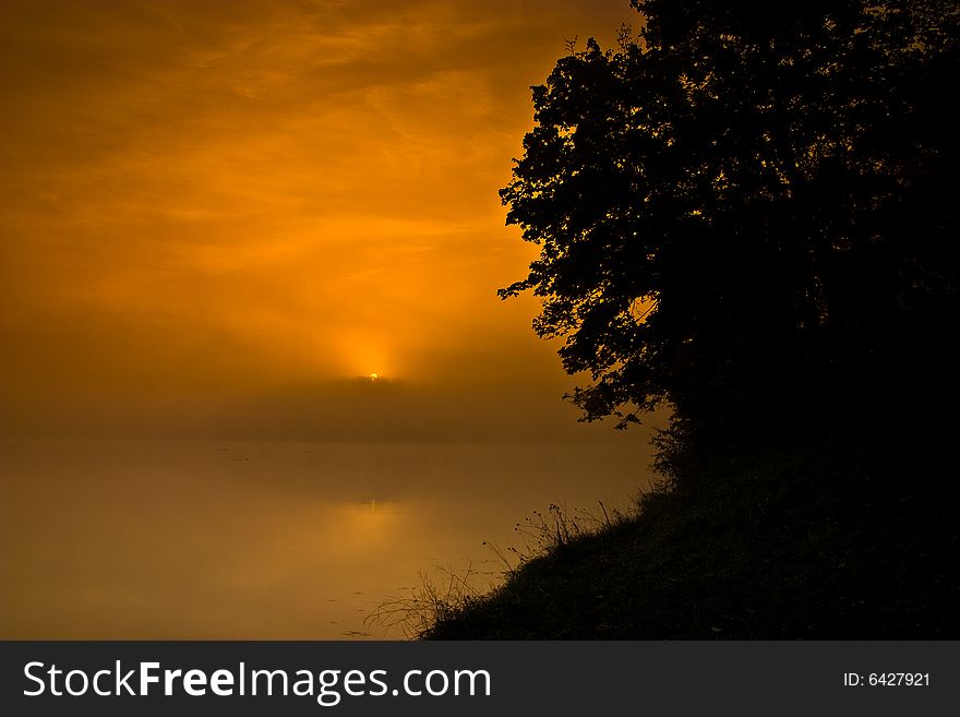 Hazy smoggy morning sunrise shining through. Hazy smoggy morning sunrise shining through