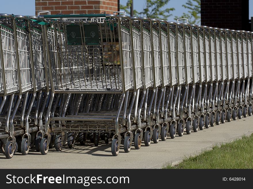 Big stack of shopping carts outside of a store