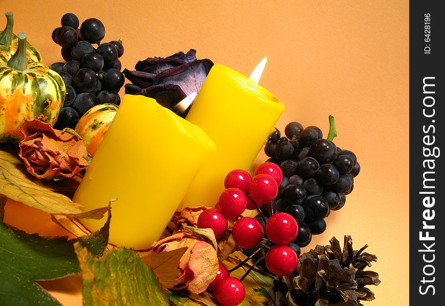 Thanksgiving Day, autumn still life with candles, leaves, grapes and pumpkins